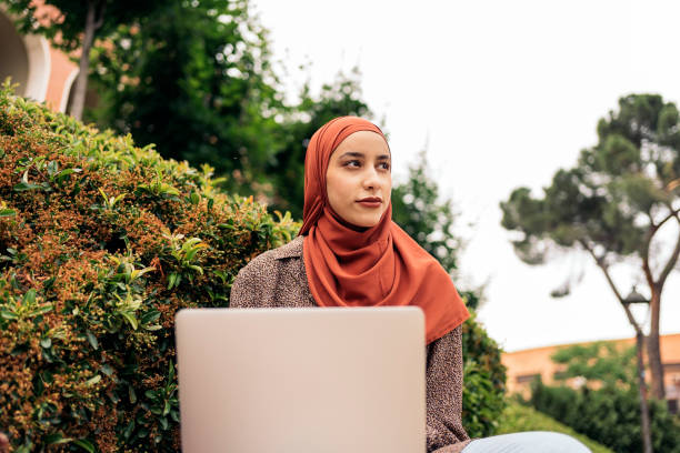 istock Pretty Muslim Woman Using Laptop 1430312334
