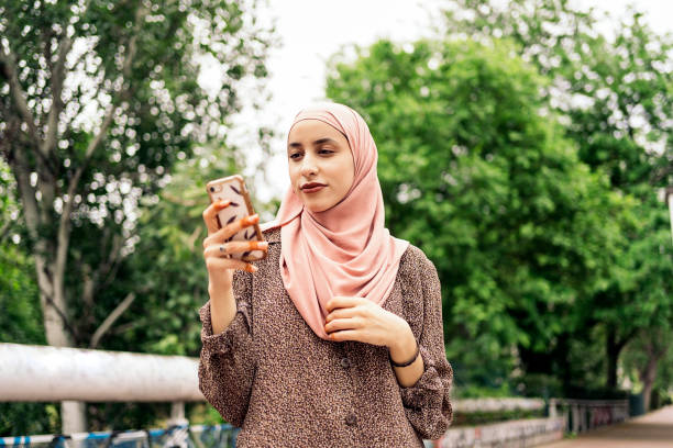 istock Muslim Woman Using Phone 1430313013