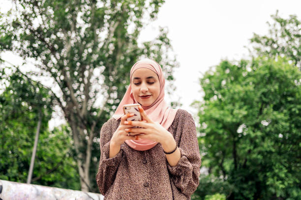 istock Happy Muslim Woman Using Cellphone 1430313030