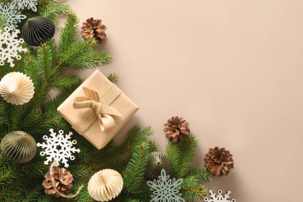 istock Christmas craft eco gift and festive composition with pine cones on beige background. 1430318678
