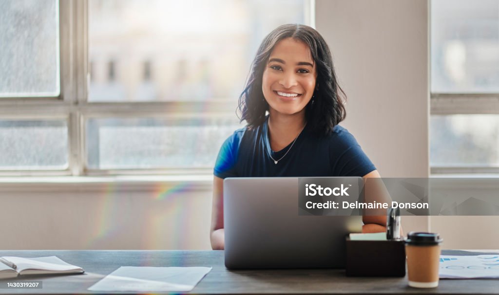 Business woman, smile and working on laptop in office or company looking happy and satisfied. Portrait of Brazilian female worker or employee typing email on computer and planning strategy for vision Using Computer Stock Photo