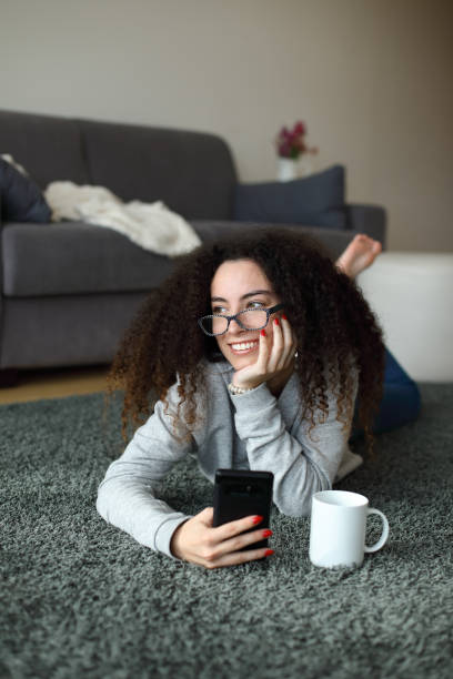 istock Relaxed casual girl texting on smartphone at home 1430320883