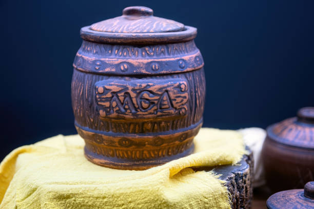 istock Clay pot for honey isolated on dark blue background. 1430321611