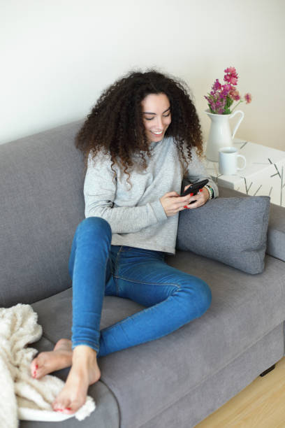istock Relaxed girl at home using smartphone 1430321924