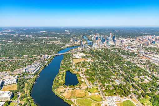 Wide angle aerial view of the Austin, Texas metro area including downtown and its neighboring communities shot from an altitude of about 1200 feet over the Colorado River.