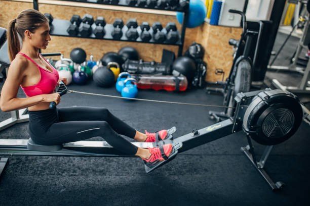 istock Woman exercising on rowing machine 1430324579