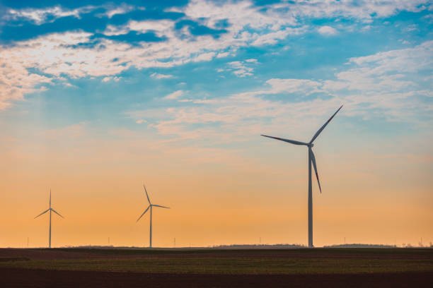 istock Turbines on wind farm under the cloudy orange colored sky at dusk 1430327638