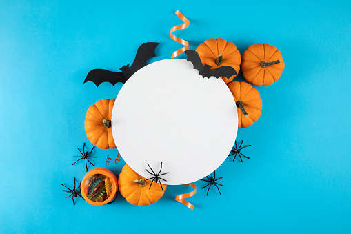 Halloween background with pumpkins bats and related objects on blue background
