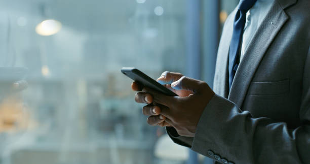istock Hands, phone and communication with a business man networking online with 5g mobile technology. Internet, email and connectivity with a male employee sending a text message or chatting at night 1430329612