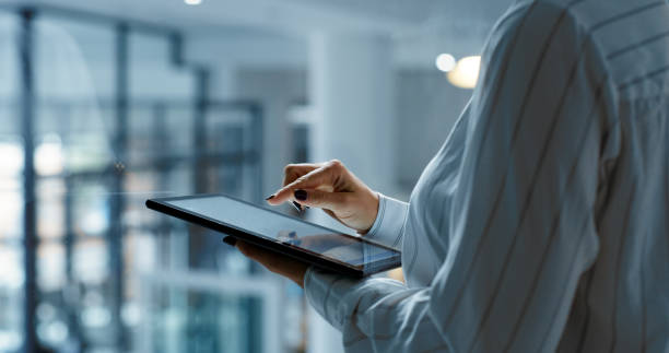 istock Hands, tablet and research with a business woman working on technology in an office. Database, information and internet with the hand of a corporate employee on a wireless digital device at work 1430330927