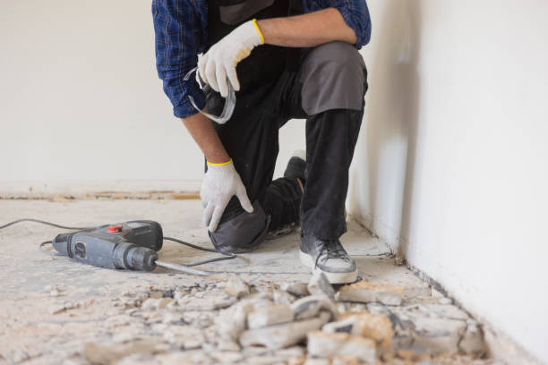 istock A man's legs between which he holds a jackhammer scrapes the floor old tiles apartment renovation 1430334356