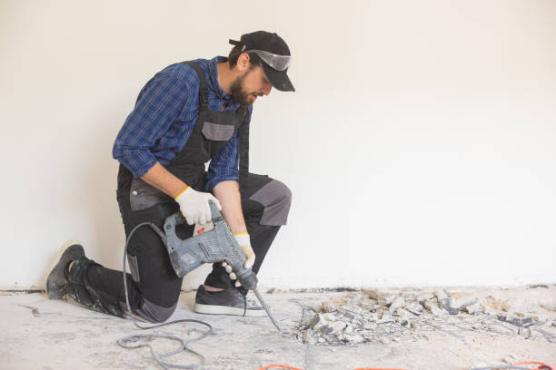 istock View of a construction worker using a hand-held demolition hammer and breaker to demolish walls to remove old floor tiles during renovation work 1430334456