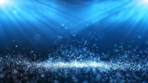 istock White particle on blue background. Small dust particle fly and light ray shine effect. 1430334553