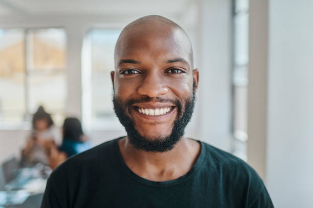 istock Creative startup and black man portrait in business internship opportunity optimistic in office. African employee with proud, happy and excited smile for mentorship training in Jamaica company. 1430334694