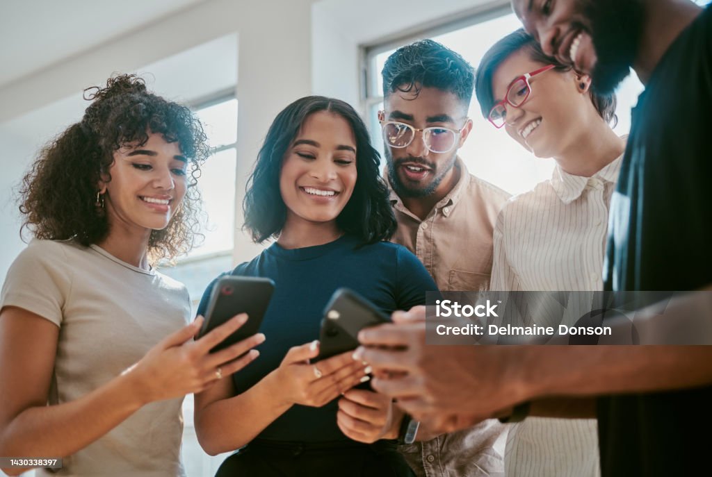 Networking, teamwork and phone collaboration with digital team working on brand and app logo in an office. Startup, vision and diversity with partner coworkers planning success with online project Employee Stock Photo