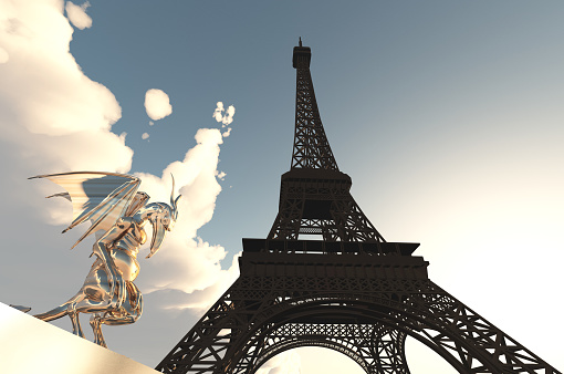 June 9, 2018 - Paris, France. A wide angle view of the Eiffel tower in Paris on a blue sky day with people walking through the park.