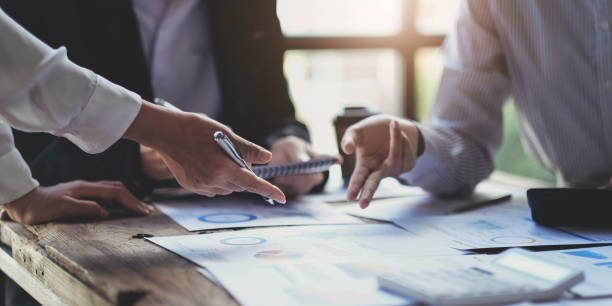 istock Business team brainstorming and discussing with financial data and report graph. Teamwork meeting working concept. 1430341014