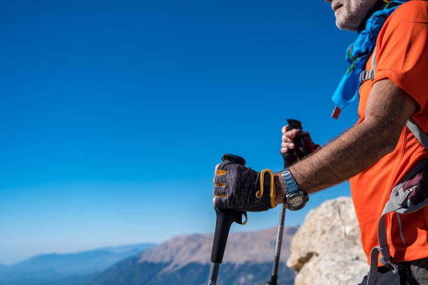 istock Old man with backpack climbing mountain, enjoying the view 1430342354