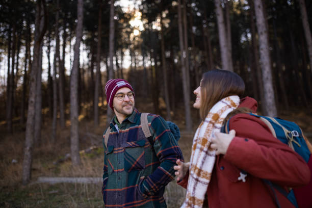 A young couple on a hiking trip in a forest