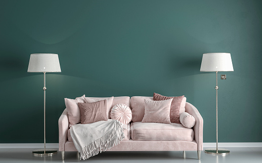 Glamour elegant living room with rose / light pink velvet sofa, decoration on a gray tiled floor in front of empty pine green plaster wall with copy space, and two elegant lamps on both sides of the sofa. A slight vintage effect was added. 3D rendered image.