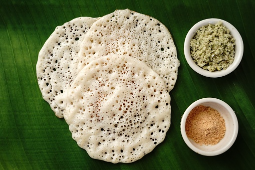 Indian breakfast Dosa with chutney served in banana leaf