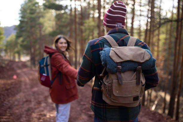 istock Young couple walking together on a forest hiking trip 1430345065