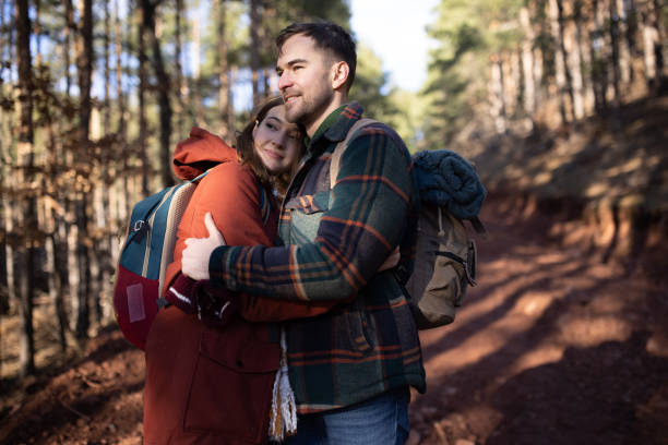 istock Young couple embracing while on a forest hiking trip 1430345696