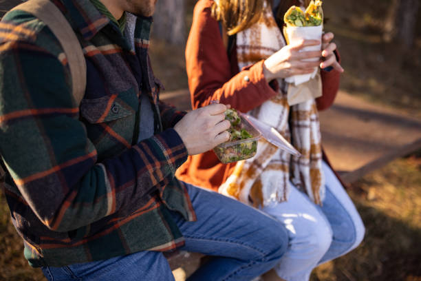 istock Young couple resting and eating on a hiking trip 1430345801