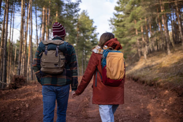 istock Young couple walking together in a forest 1430345978