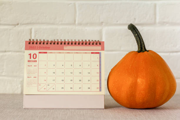 istock Hello, October.Desktop calendar for October 2022 on the table next to the pumpkin. 1430346715