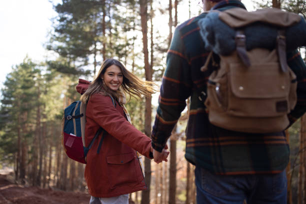 istock Young couple walking together on a forest hiking trip 1430347175