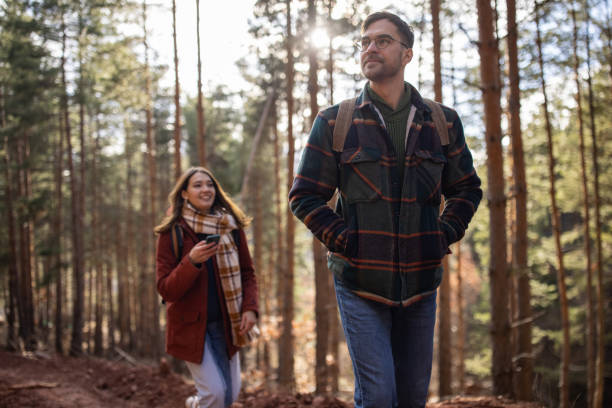 istock Young couple walking together on a forest hiking trip 1430347189