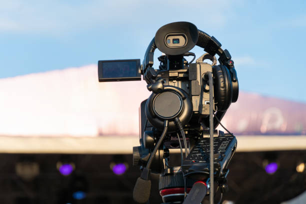 istock Professional digital video camera shoots video outdoors on a sunny day, rear view 1430349691
