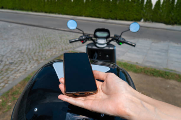istock Woman's hand using a mobile phone scans the QR code on a motorcycle scooter on a sunny day. Transport rental concept 1430350247