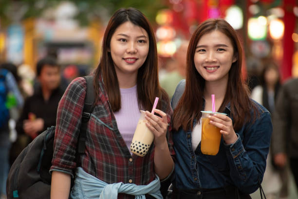 istock Two Asian women enjoy bubble milk tea and looking at camera 1430352281