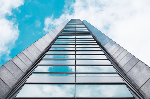 underside panoramic and perspective view to steel blue glass high rise building skyscrapers, business concept of successful industrial architecture