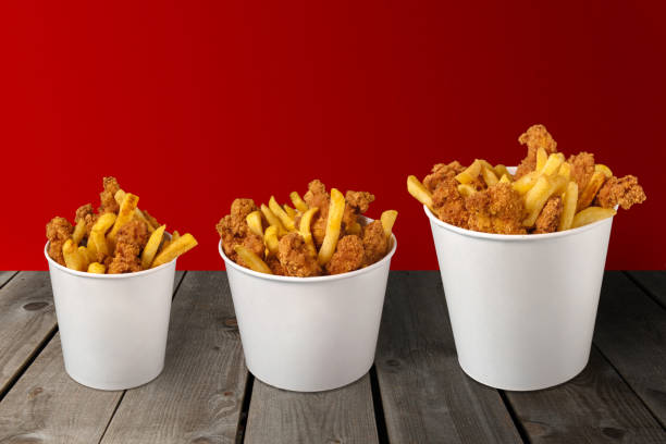 Close up shot of grilled chicken and french fries inside a styrofoam takeout boxes during Covid 19 pandemic
