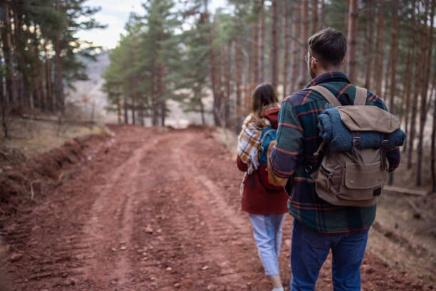 istock Young couple walking together on a forest hiking trip 1430356335