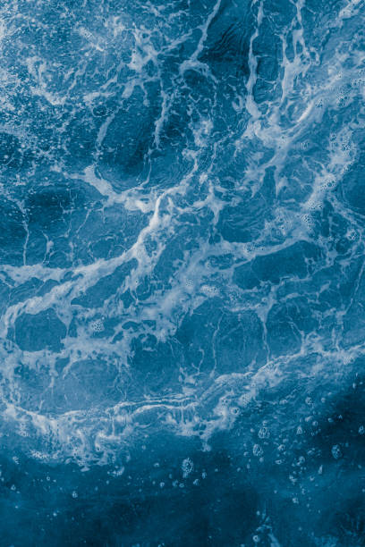 istock Dark blue sea surface with waves, splash and bubbles 1430358124
