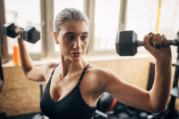 istock Woman exercising with dumbbells 1430359132