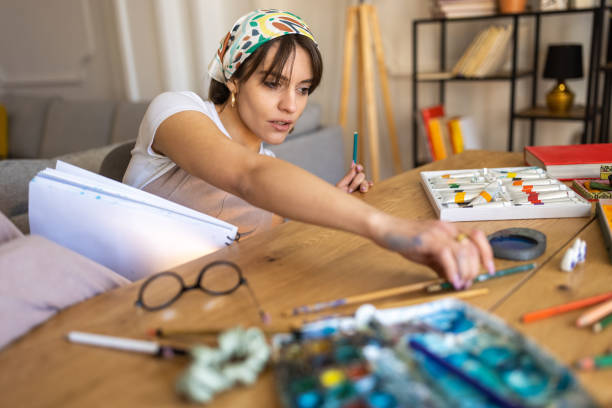 istock Young female artist drawing at home 1430361362