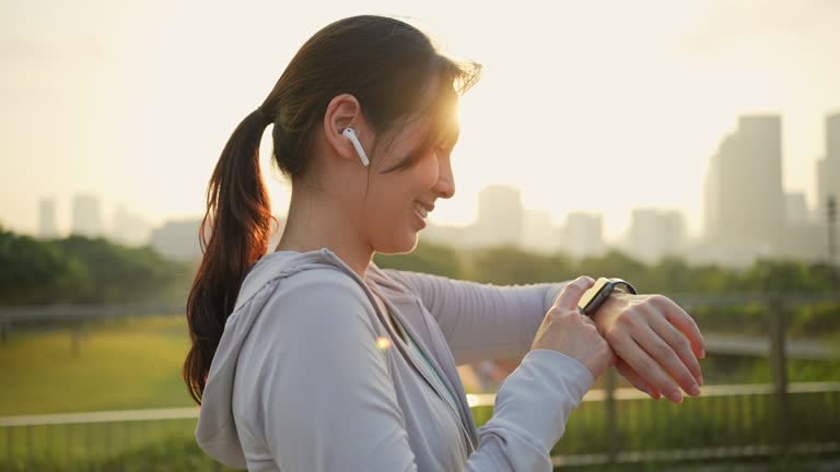 Sport woman using smart watch in city a morning