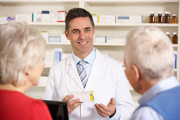 istock American pharmacist with senior couple in pharmacy 143036758