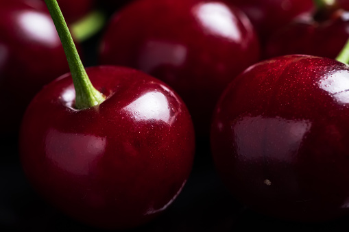 Red ripe fresh cherries in drops of water close up. Cherry background. Berry pattern and texture. Food background