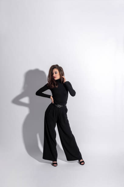 istock Woman with black outfit studio portrait on white background with copy space 1430369776