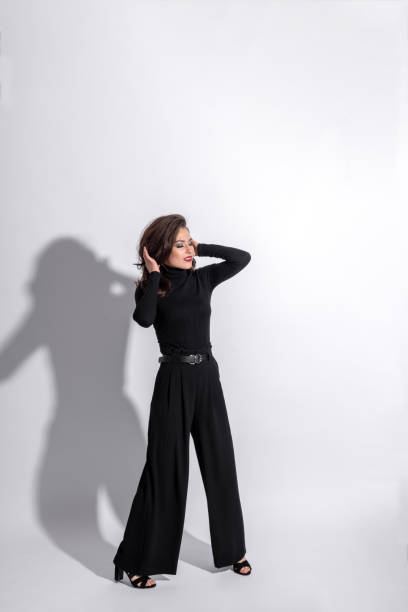 istock Woman with black outfit studio portrait on white background with copy space 1430369869