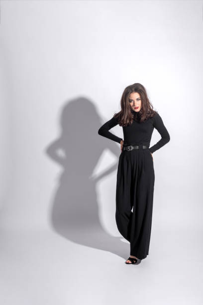 istock Woman with black outfit studio portrait on white background with copy space 1430370454