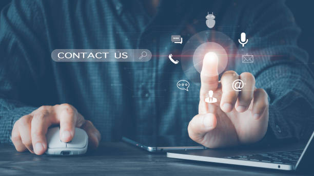 istock Contact Us Customer Support Enquiry Hotline Concept, Businessman using a laptop and touching on virtual screen contact icons email, address, live chat, internet 1430370650