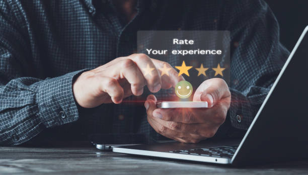 istock Man using hands holding smartphone Rate your experience,high key and give five-star symbol to increase the rating of product and service Customer service experience and business satisfaction survey. 1430370705