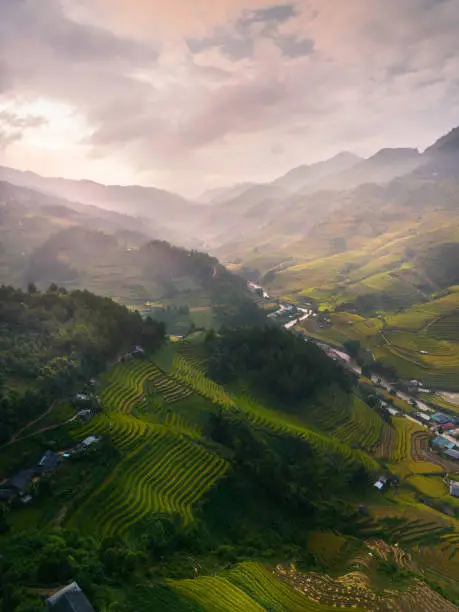 Photo of Aerial view of golden rice terraces at Mu cang chai town near Sapa city, north of Vietnam. Beautiful terraced rice field in harvest season in Yen Bai, Vietnam